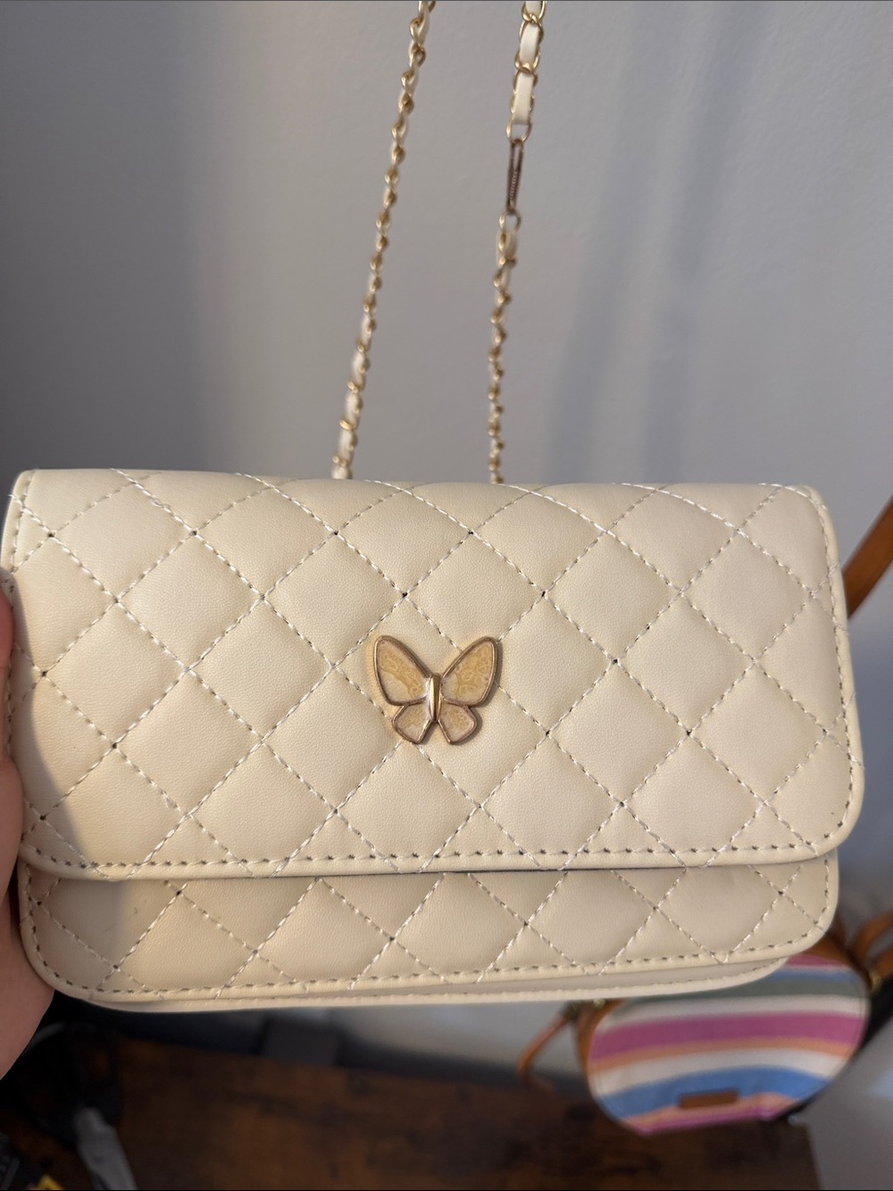 Chic Quilted Cream Crossbody Bag with Gold Butterfly Accent
